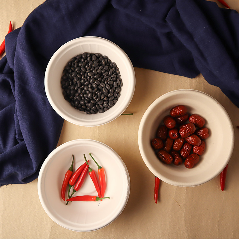Three light-colored bowls holding beans, dates and chillies